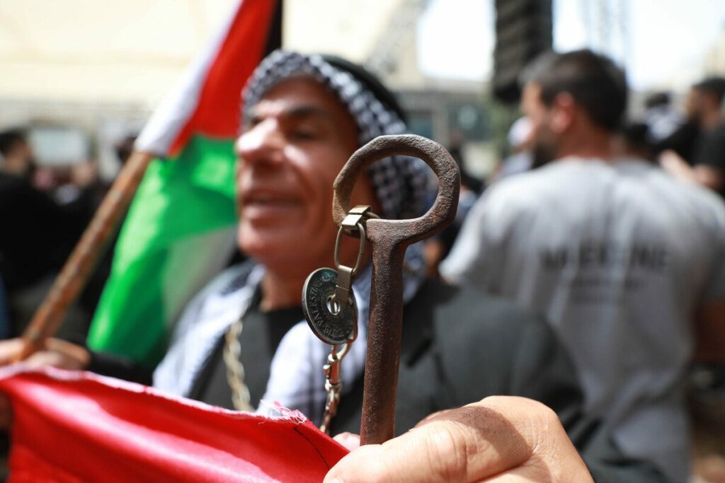 Palestinian refugee showing the key of her home from where he was displaced during Nakba in 1948