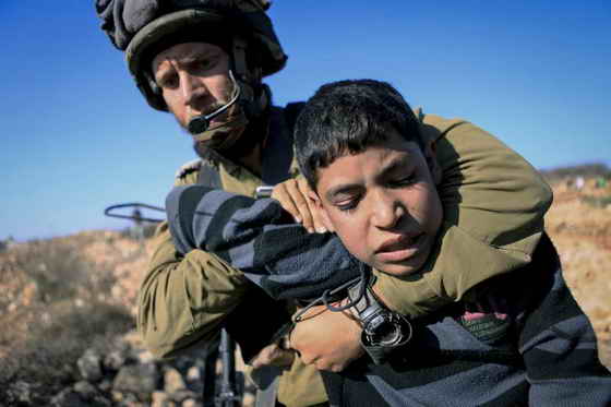 Israeli soldiers arresting aggressively a Palestinian child