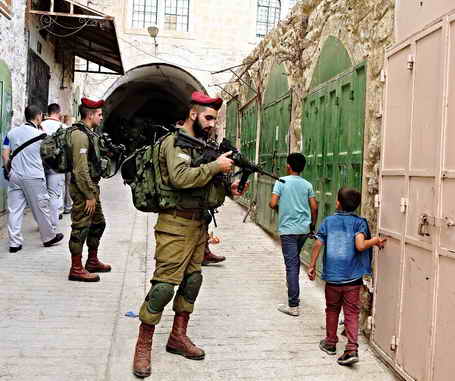 Palestinian children in Hebron in line of fire of Israeli soldier