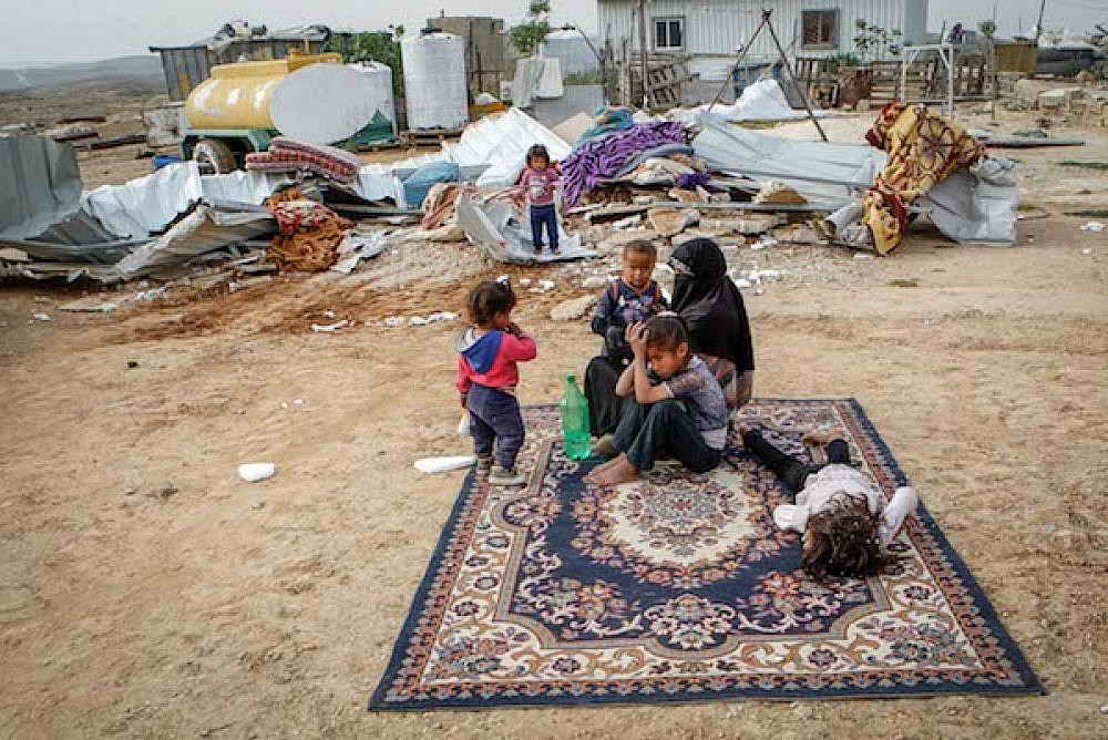 Palestinian mother with 5 childrenin front of demolished house by israelis